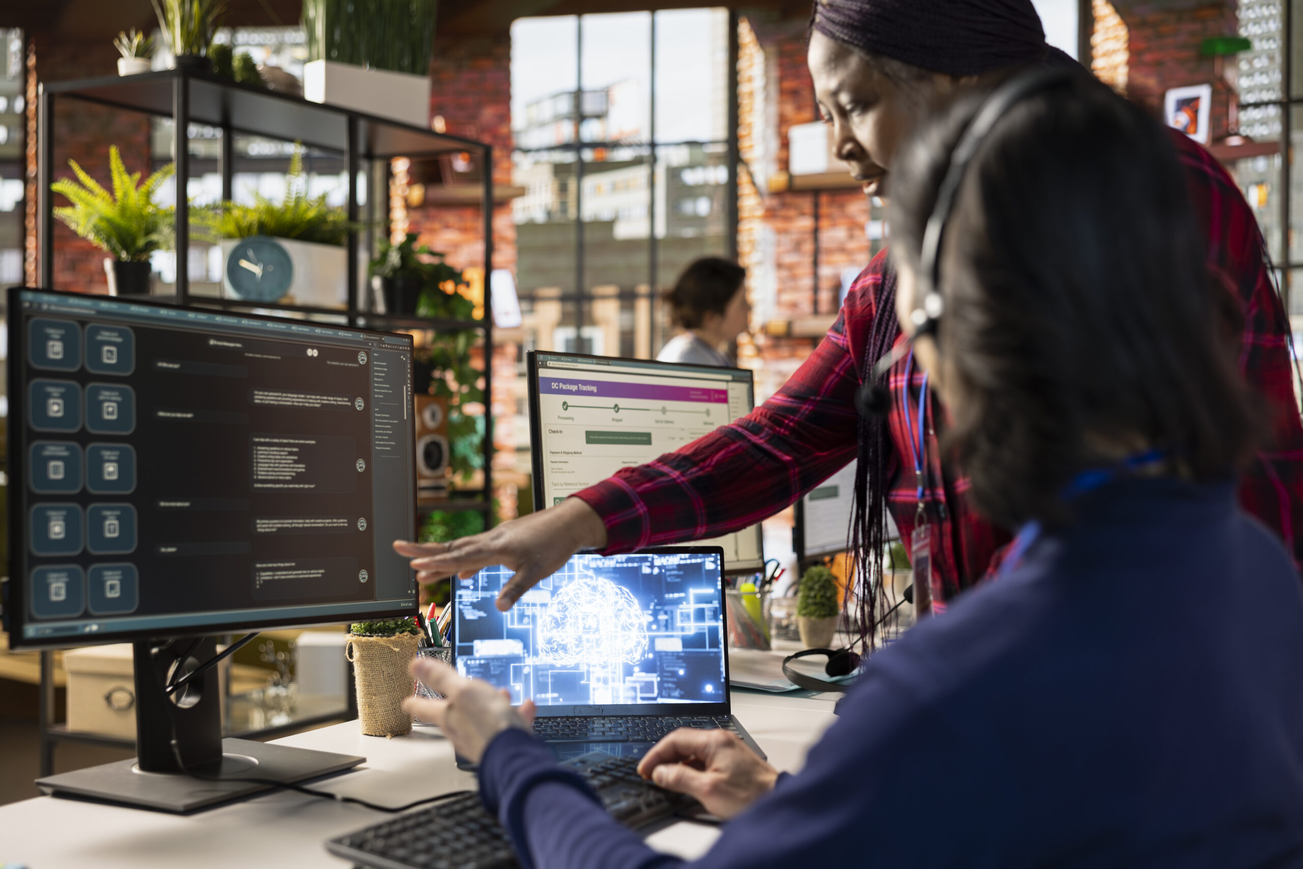 Manager in call center shows man how to use company AI software Smart Routing & Workflow Automation